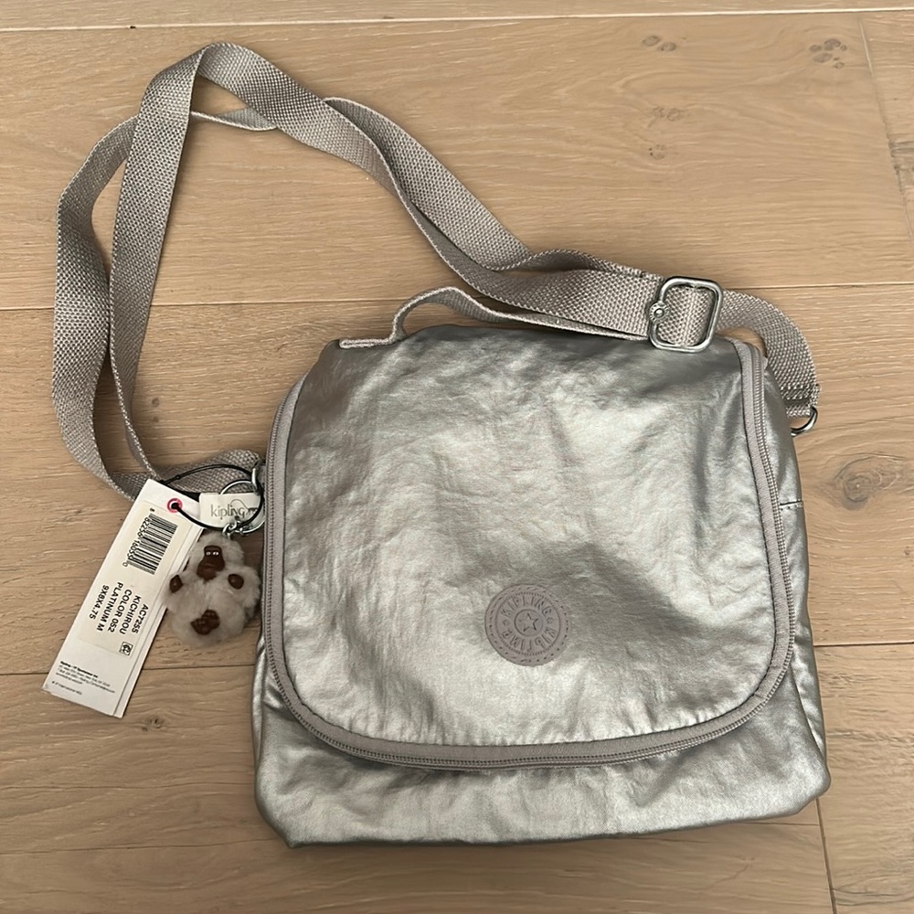 Kipling silver cross body bag. Never used. New with tags. Model AC7255